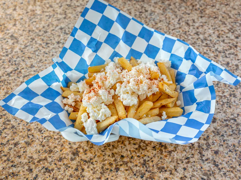 Seasoned fries topped with crumbled feta