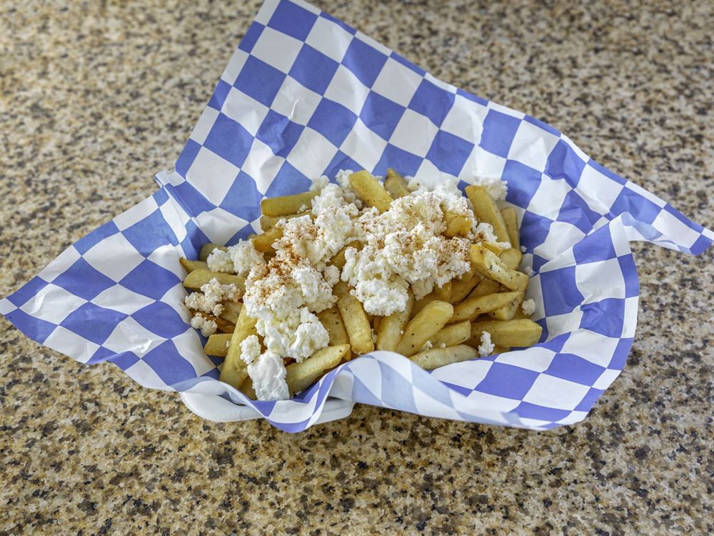 Seasoned fries topped with feta