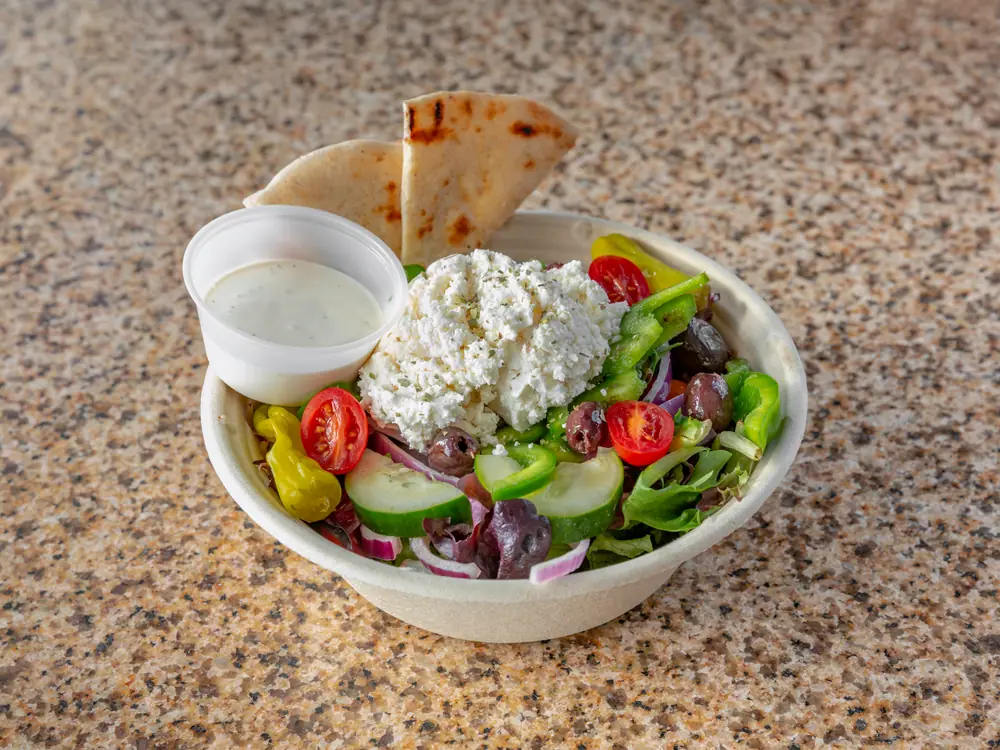 Greek salad with feta, peppers, olives and pita