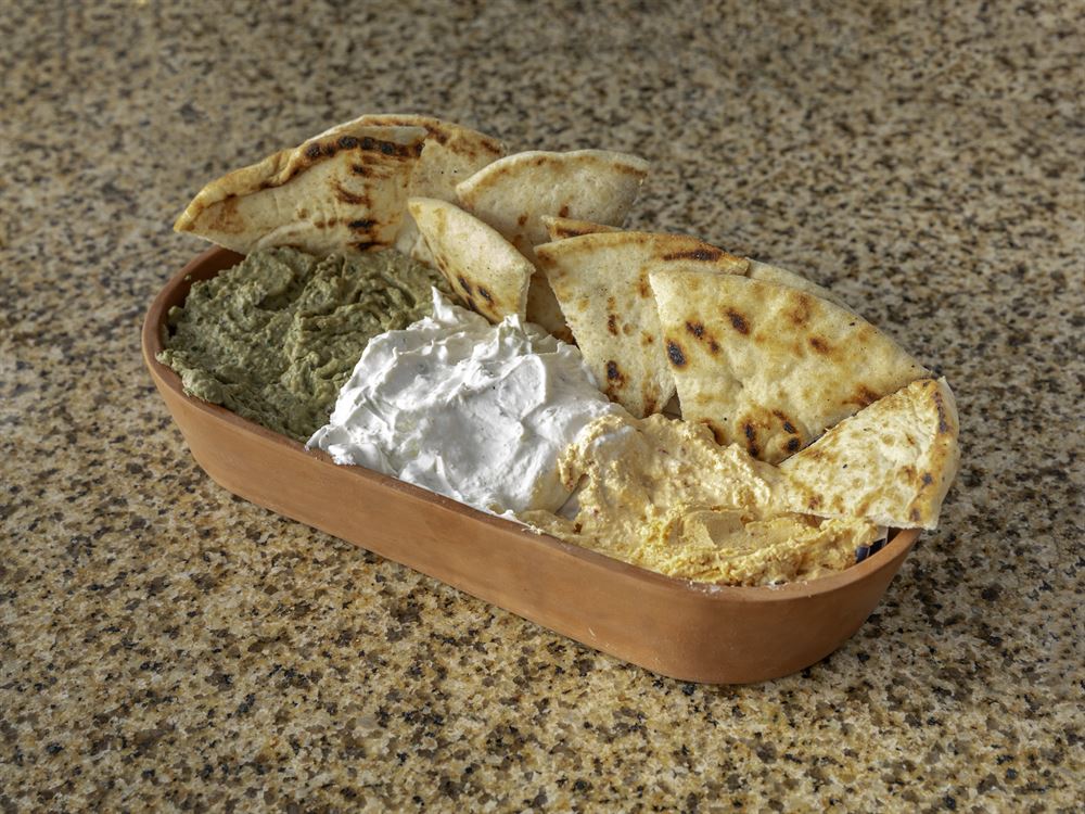 Trio of Greek spreads with grilled pita
